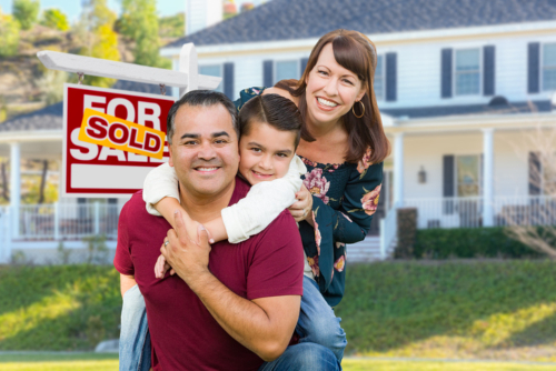 Happy Mixed Race Family In Front of House and Sold For Sale Real